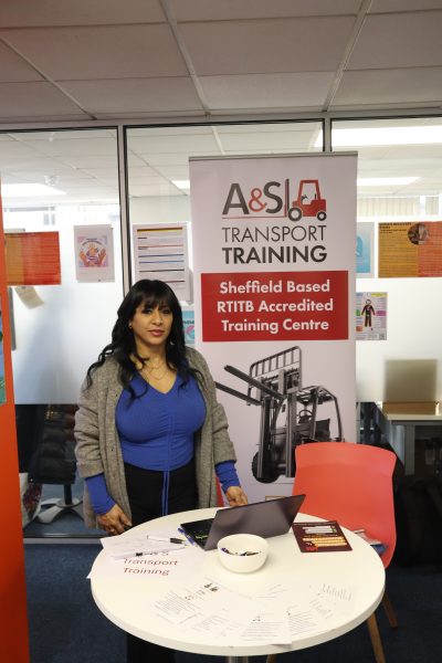 Woman stands in front of banner that says 