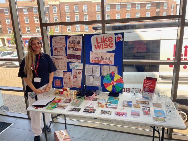 Staff member standing in front of likewise alcohol stall